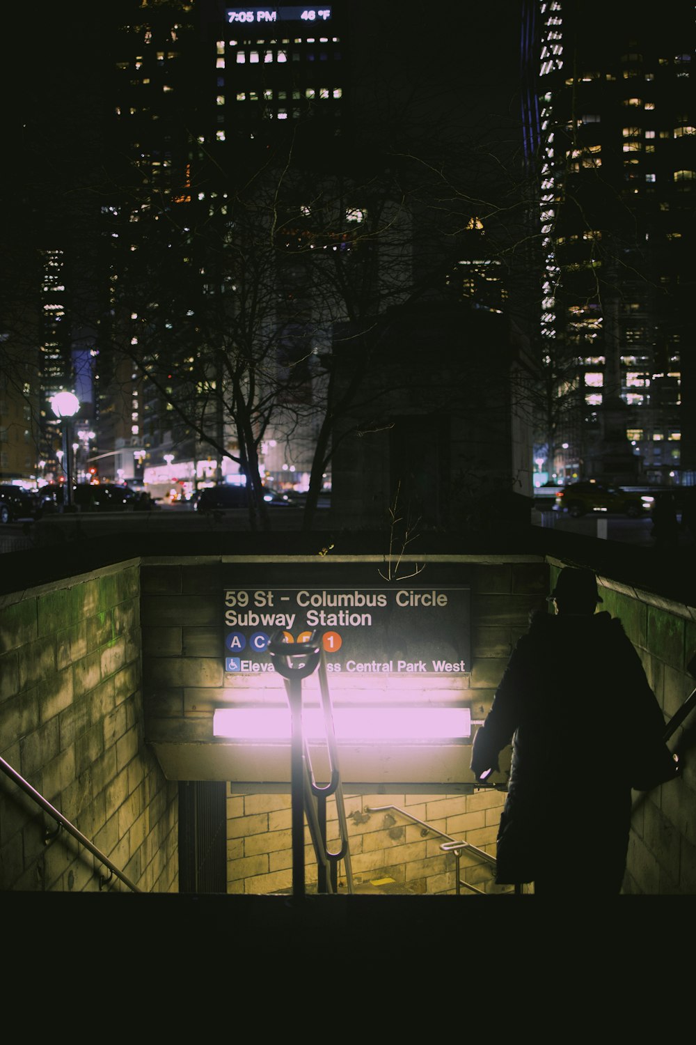 a subway station at night with the lights on