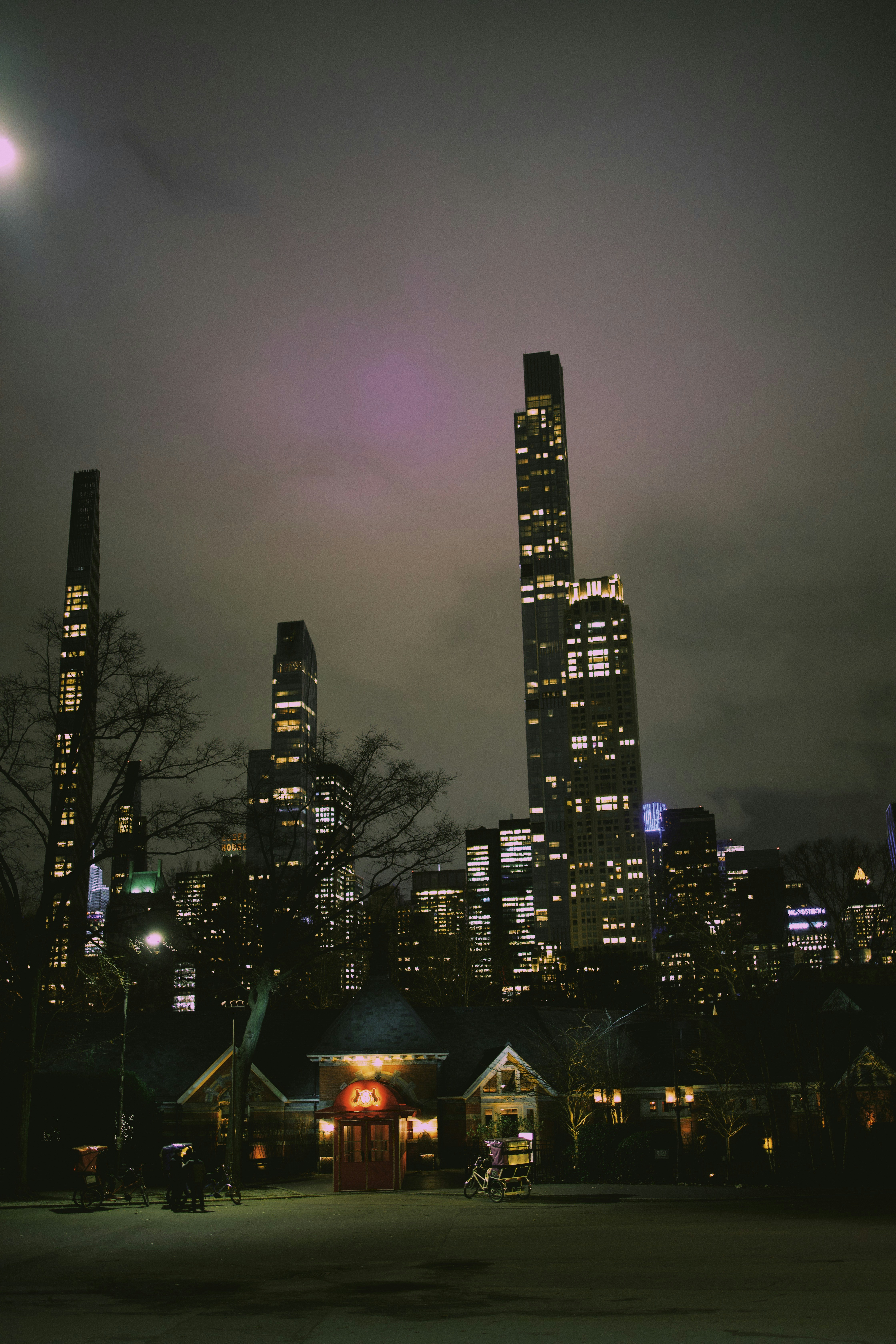 A city skyline at night with buildings lit up photo – Free Grey Image ...