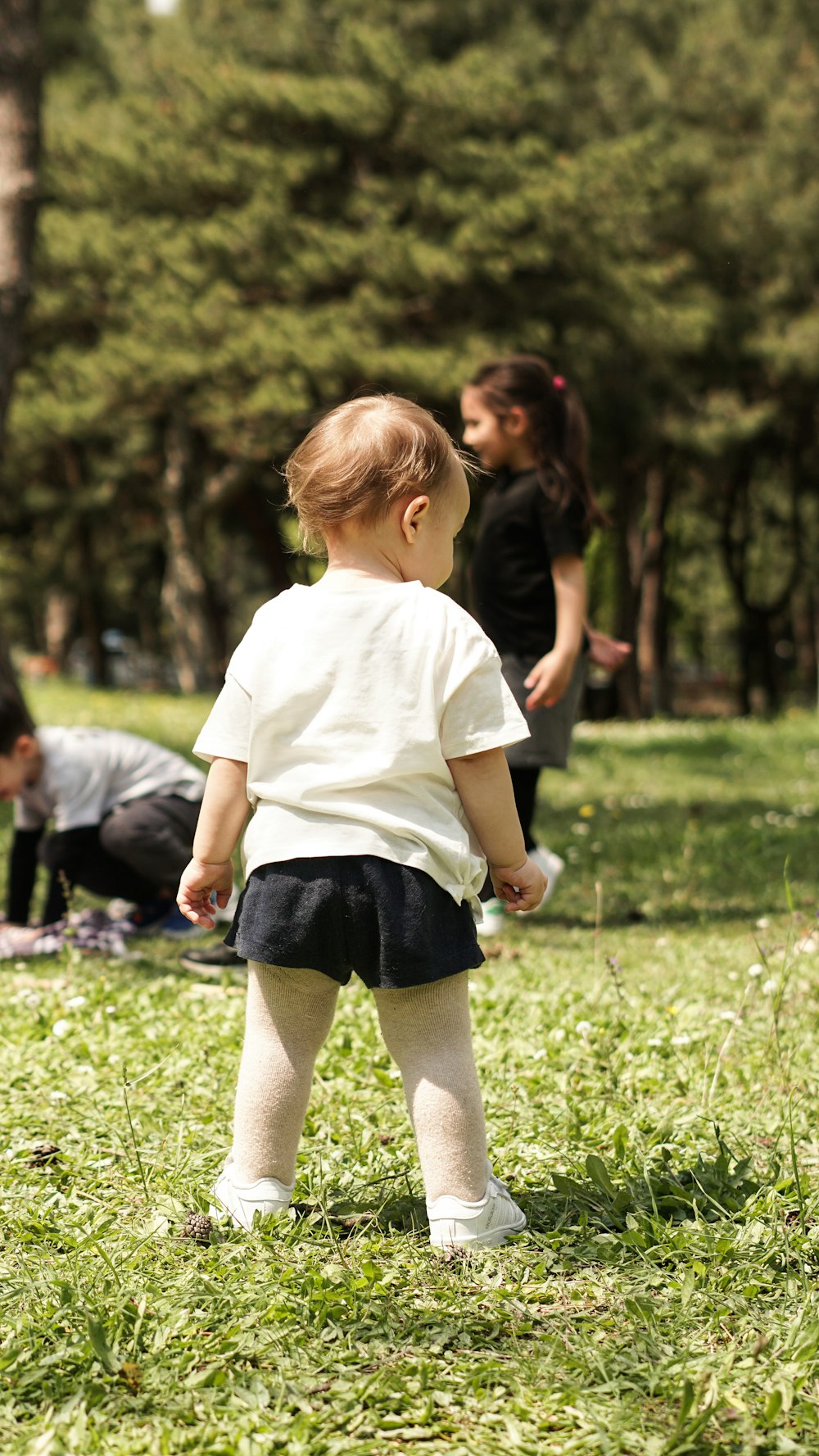 a little girl standing in the grass with a frisbee