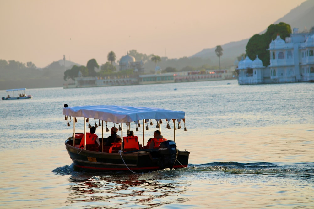 a group of people on a boat in the water