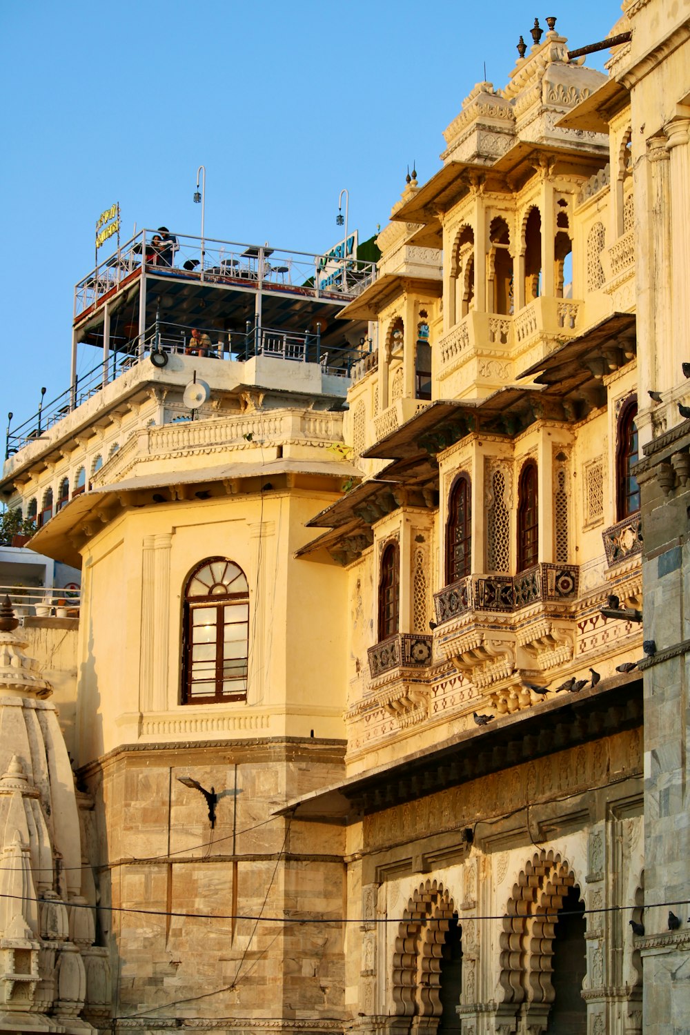 a large yellow building with a clock on the front of it