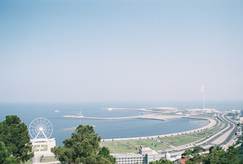 a view of a large body of water and a ferris wheel