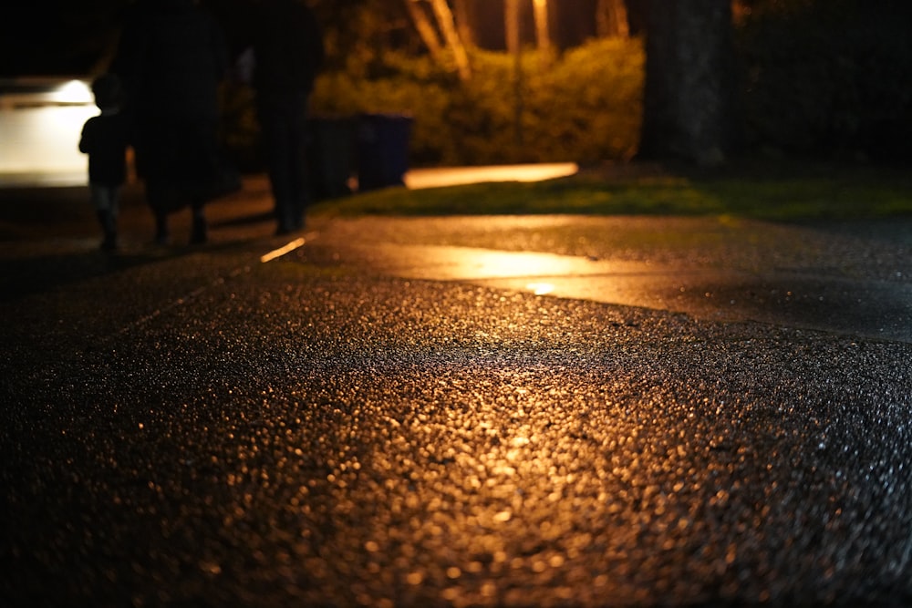 a person walking down a street at night