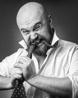 a bald man with a tie on his neck