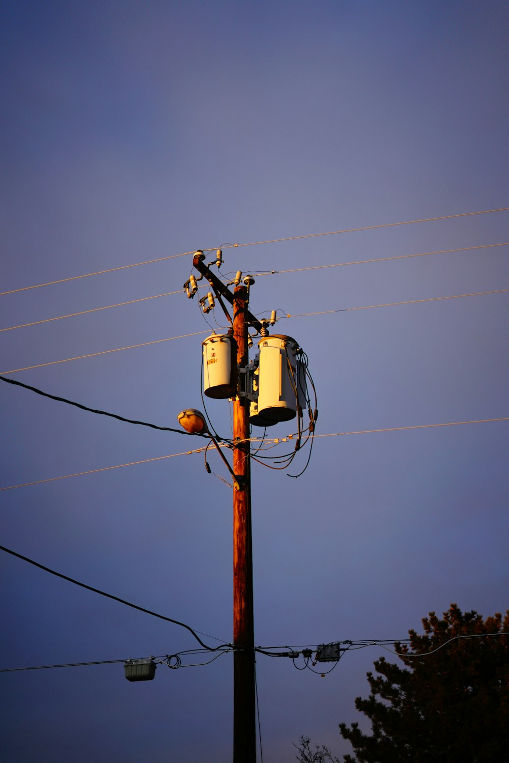 a telephone pole with a bunch of wires attached to it