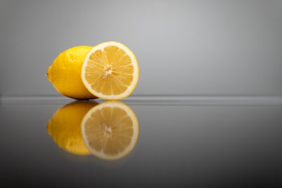 a couple of lemons sitting on top of a table