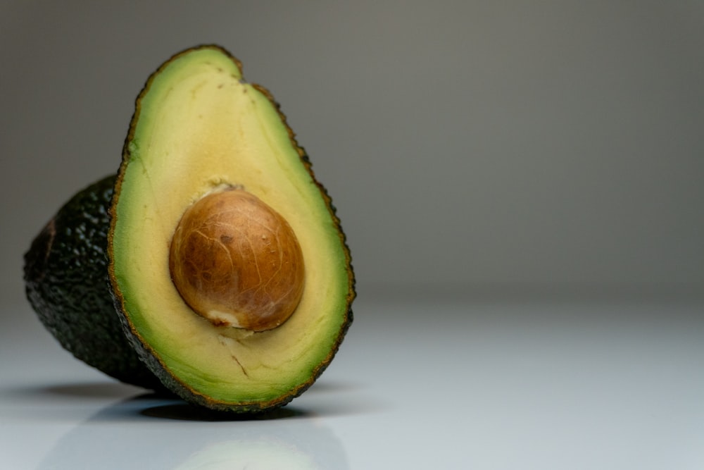 an avocado cut in half on a table