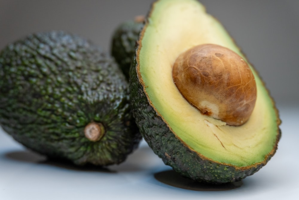 an avocado cut in half on a table