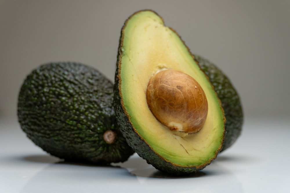 an avocado cut in half on a table