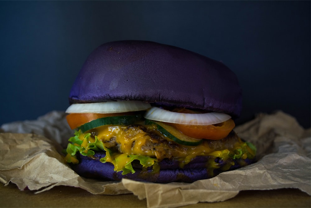 a hamburger sitting on top of a piece of wax paper