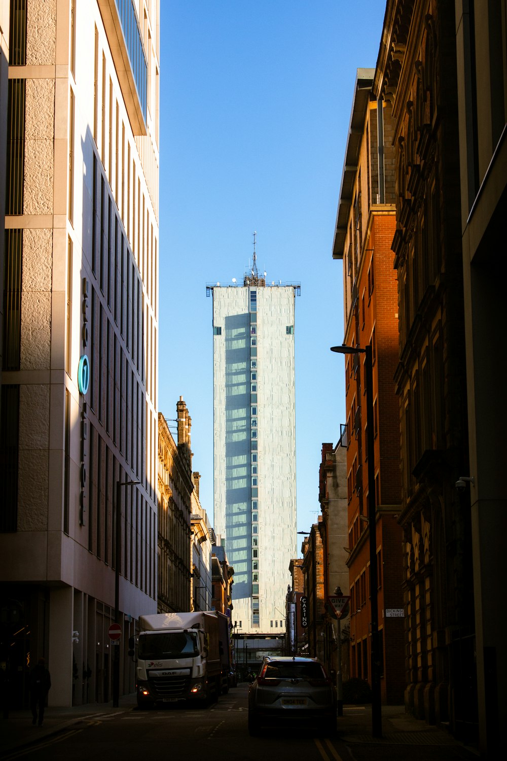 a city street with tall buildings in the background