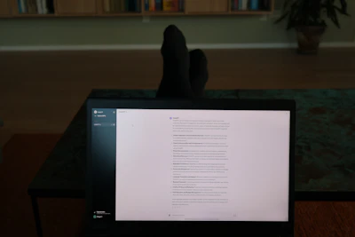 a person's feet resting on a computer screen
