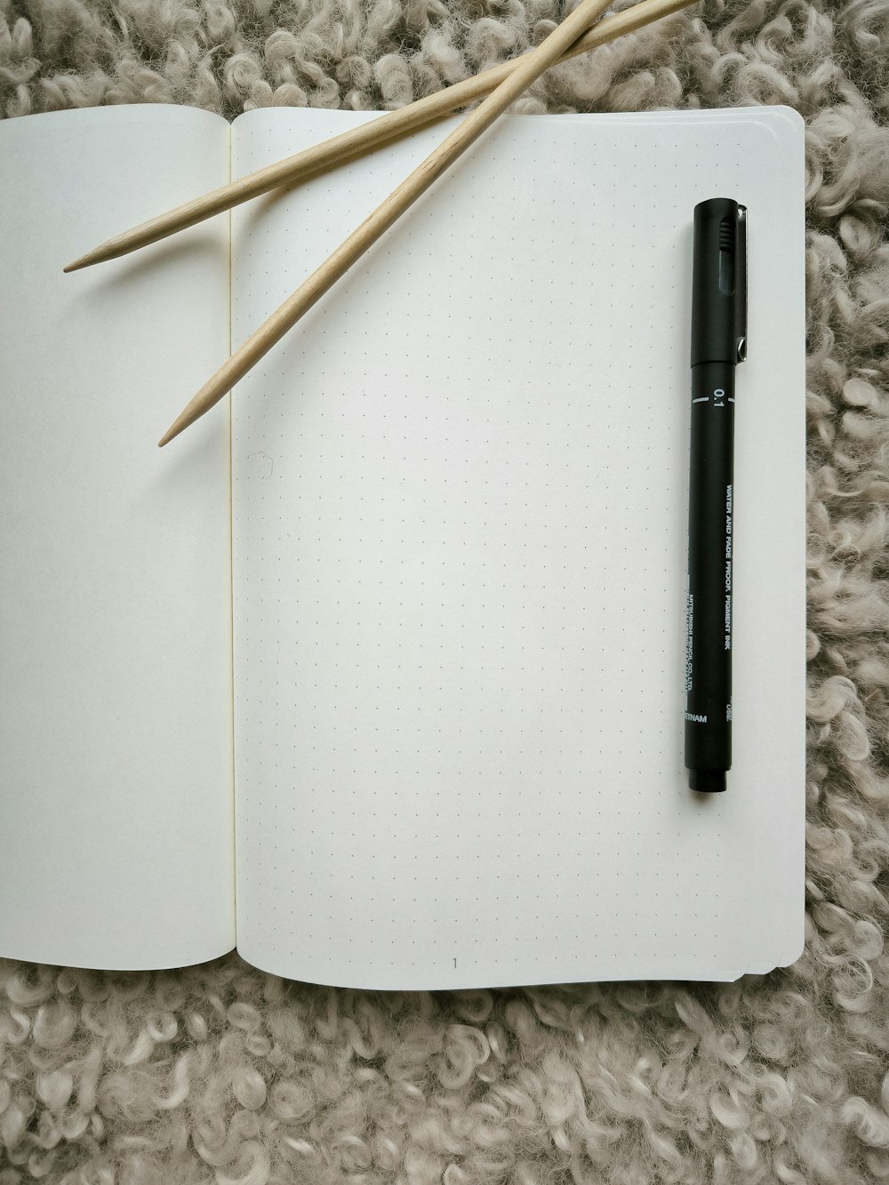 a notebook with a pen on top of it