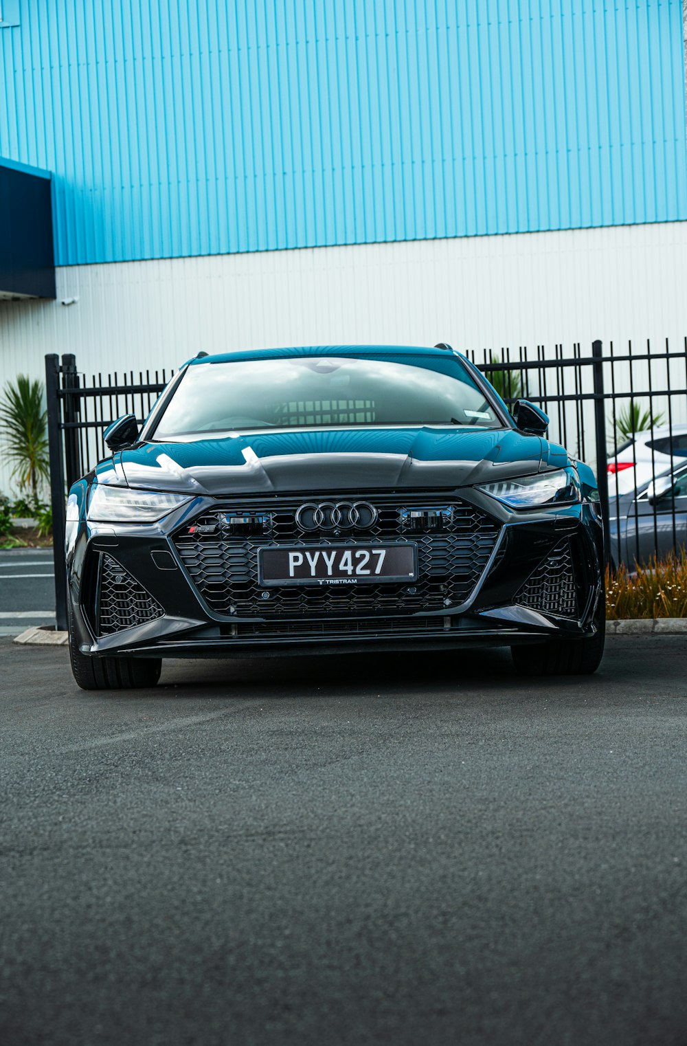 a blue car parked in front of a building