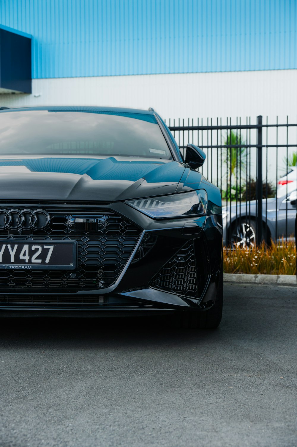 a black car parked in front of a building