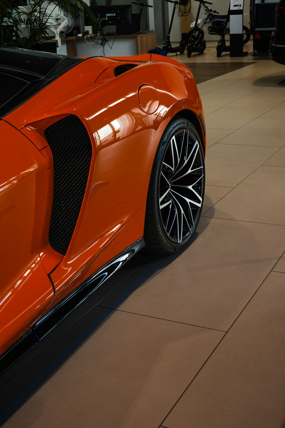 an orange sports car parked in a garage