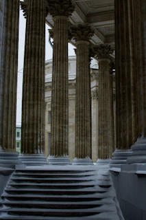 a large building with columns and steps covered in snow