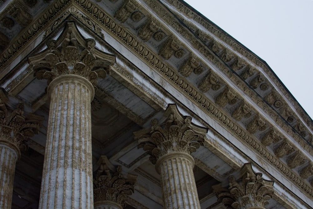 a close up of a building with columns and a clock