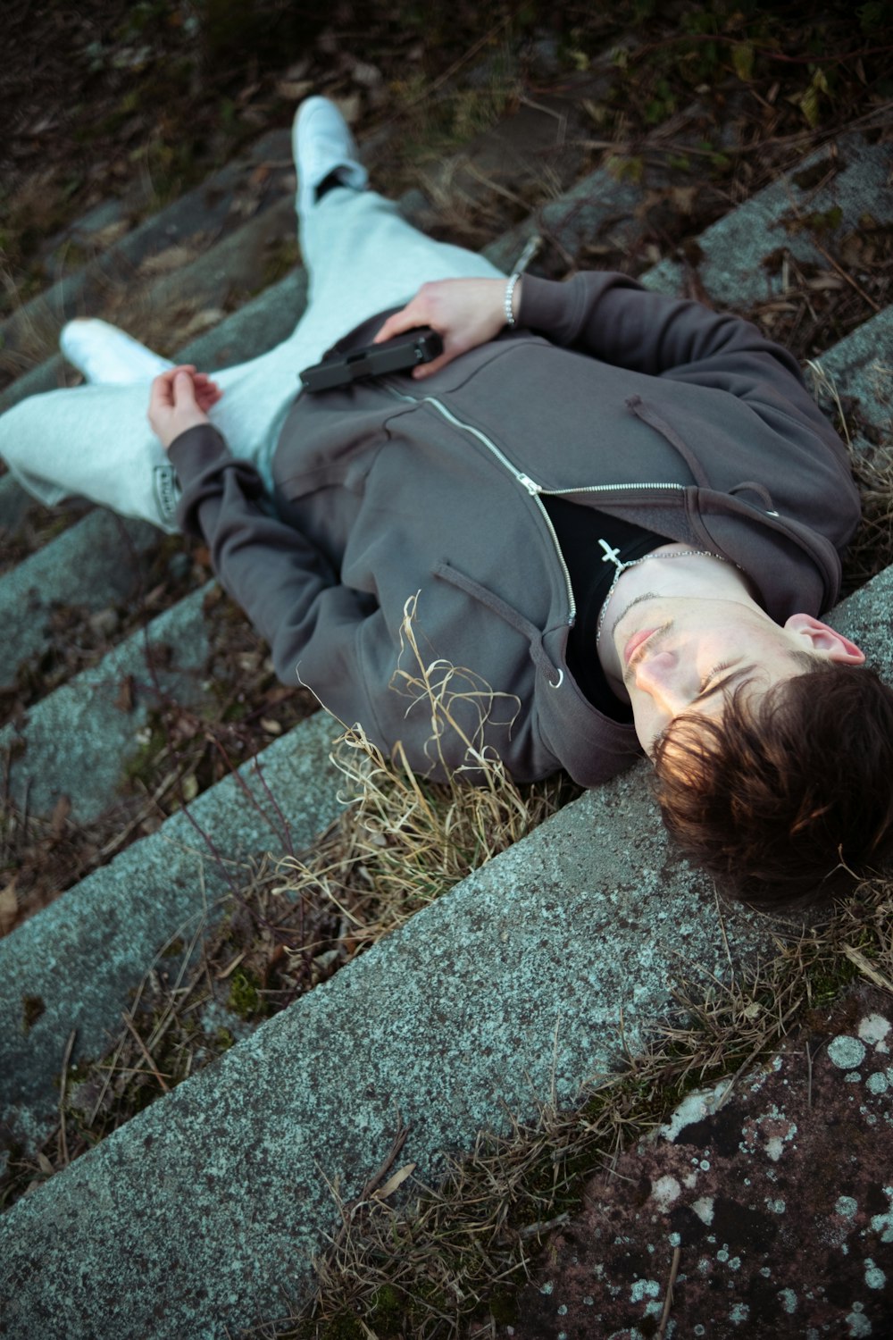 a person laying on the ground with a stuffed animal