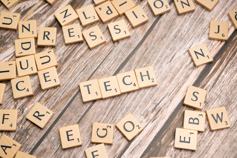 scrabble tiles spelling out words on a wooden surface