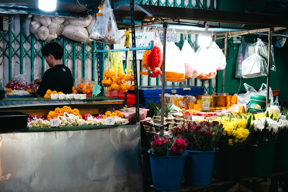 a man standing in front of a flower shop