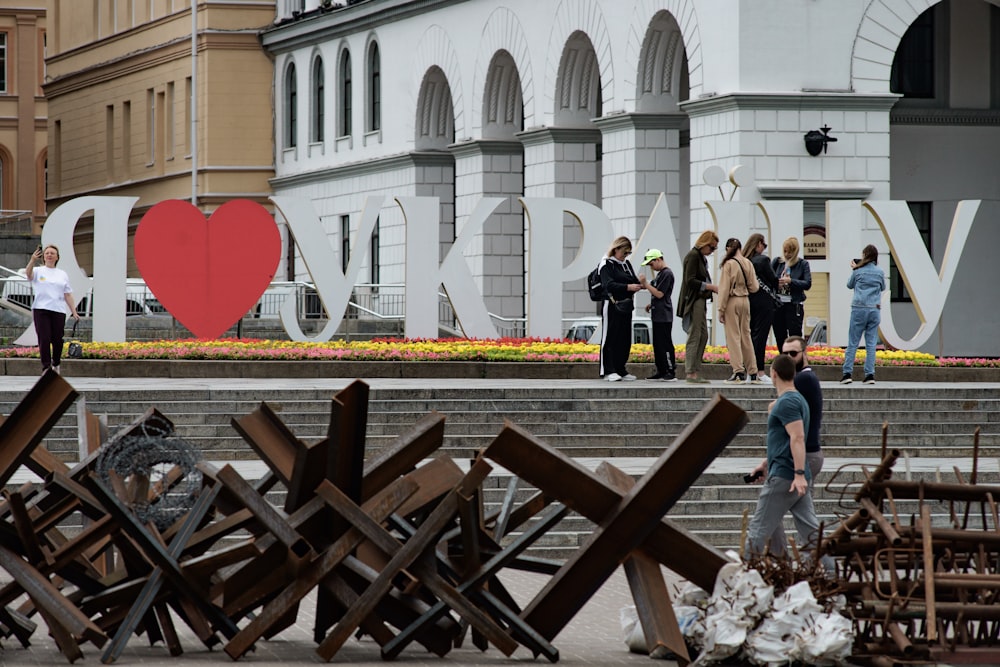 a group of people standing around a pile of junk