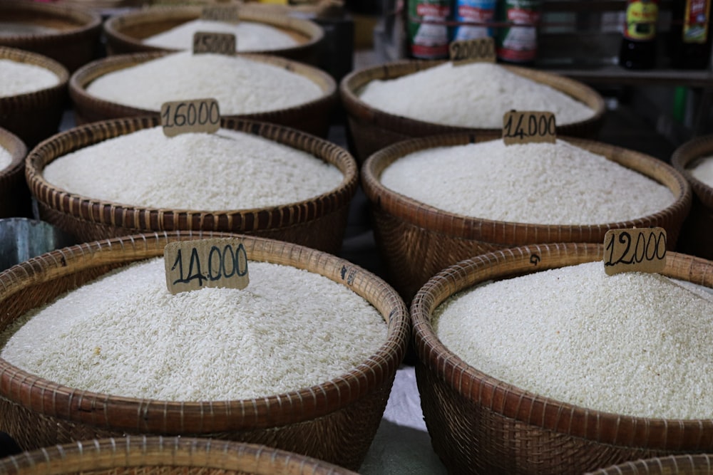 a bunch of baskets filled with white rice