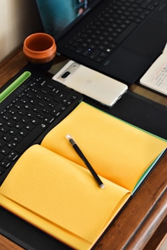 a laptop computer sitting on top of a wooden desk