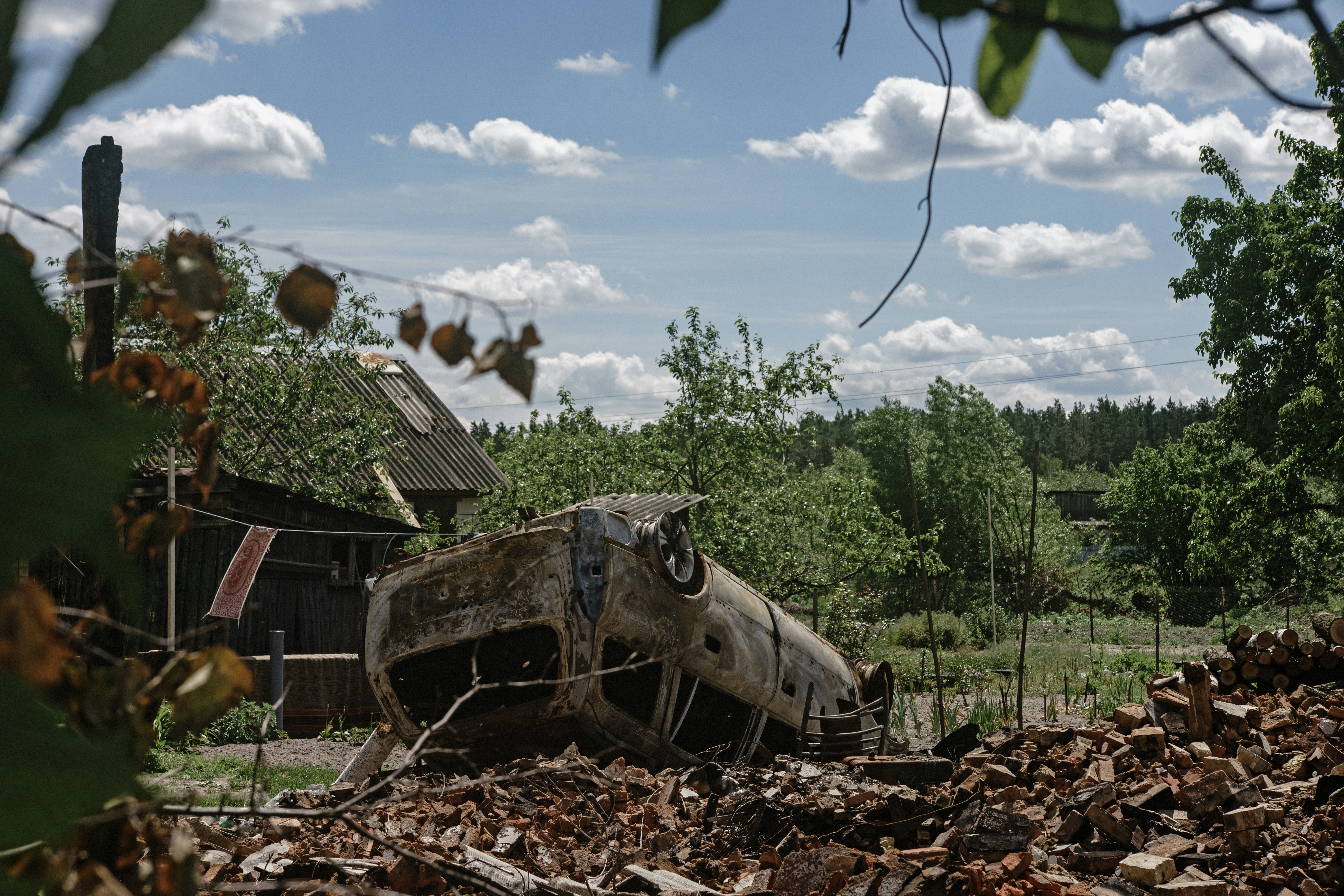an-old-car-is-sitting-in-a-pile-of-leaves-photo-free-2022-image-on