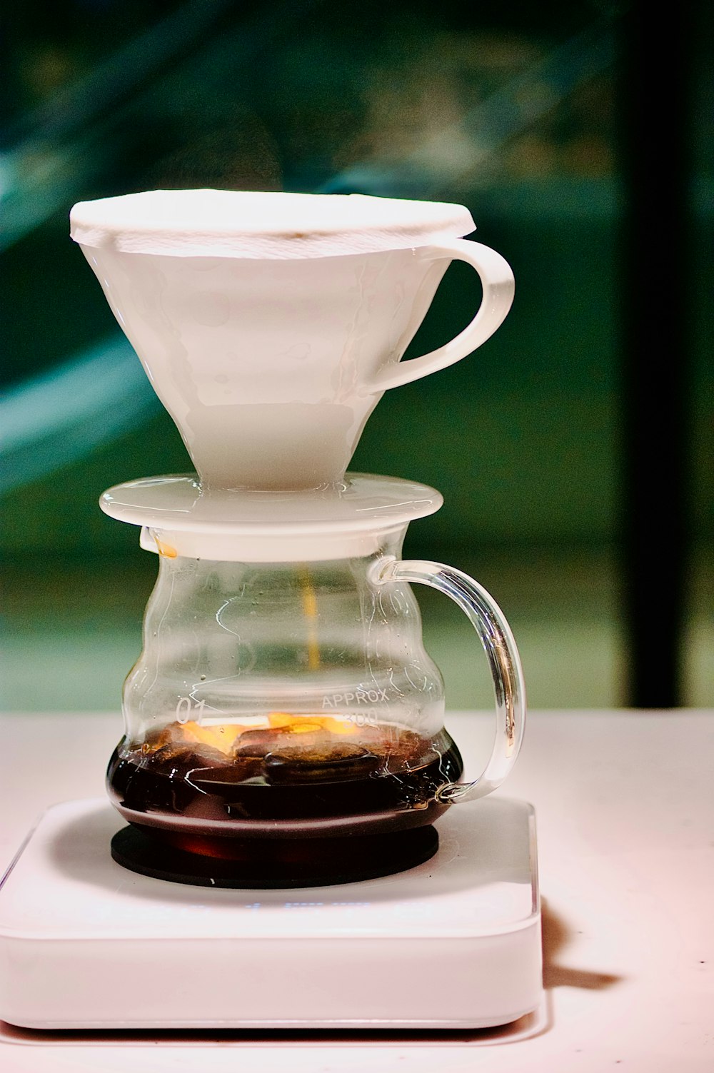 a coffee maker with a glass carafe on top of it