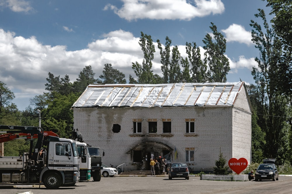 a truck and a tractor parked in front of a house