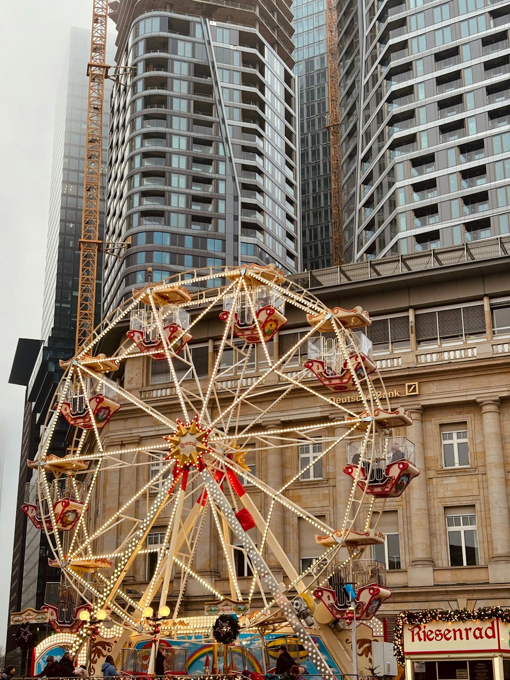 a ferris wheel in front of a tall building