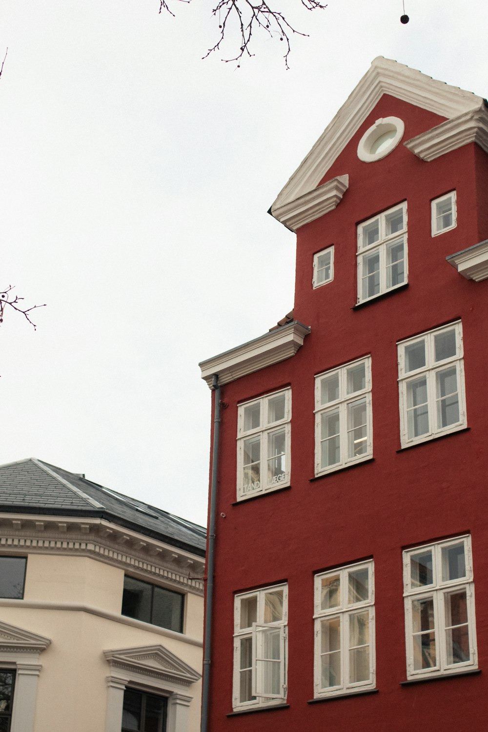 a red building with a clock on the top of it