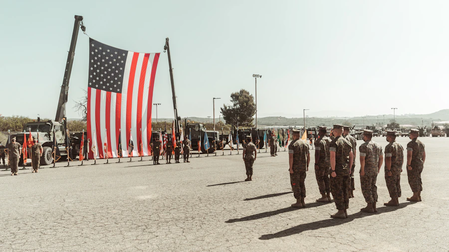 Group of U.S. military service members standing in front of an American flag