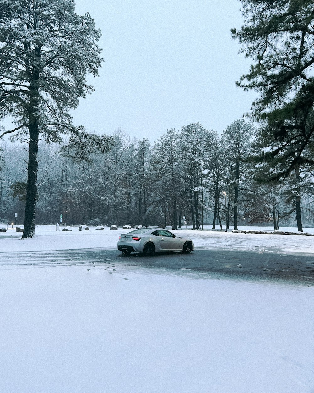 a car is parked on a snowy road
