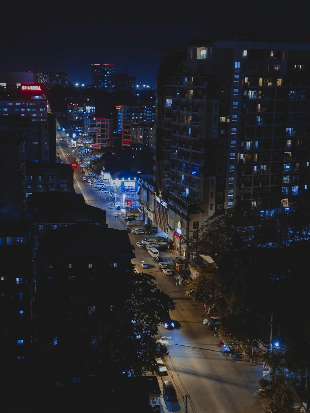 a city street at night with lots of traffic