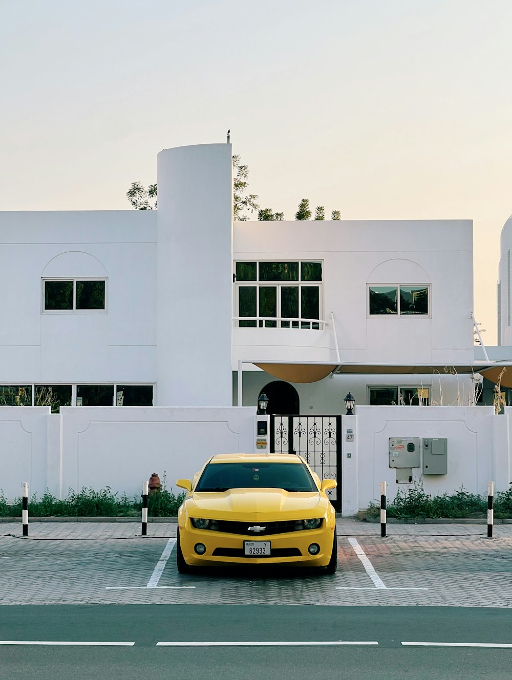 a yellow car parked in front of a white building