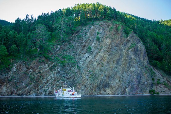 A boat on a body of water near a mountain — Lake Baikal, Russia