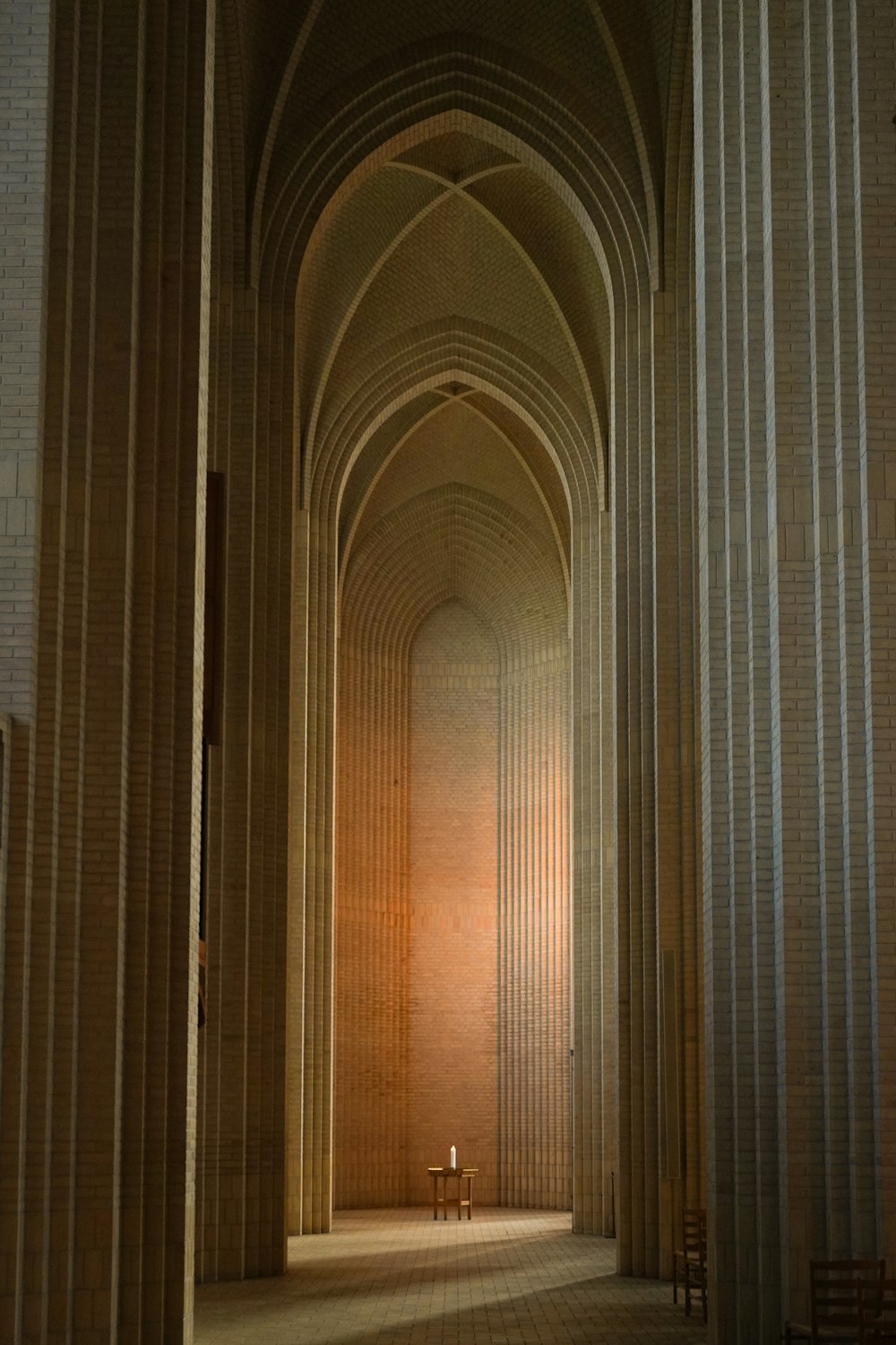 a long hallway with a bench in the middle of it