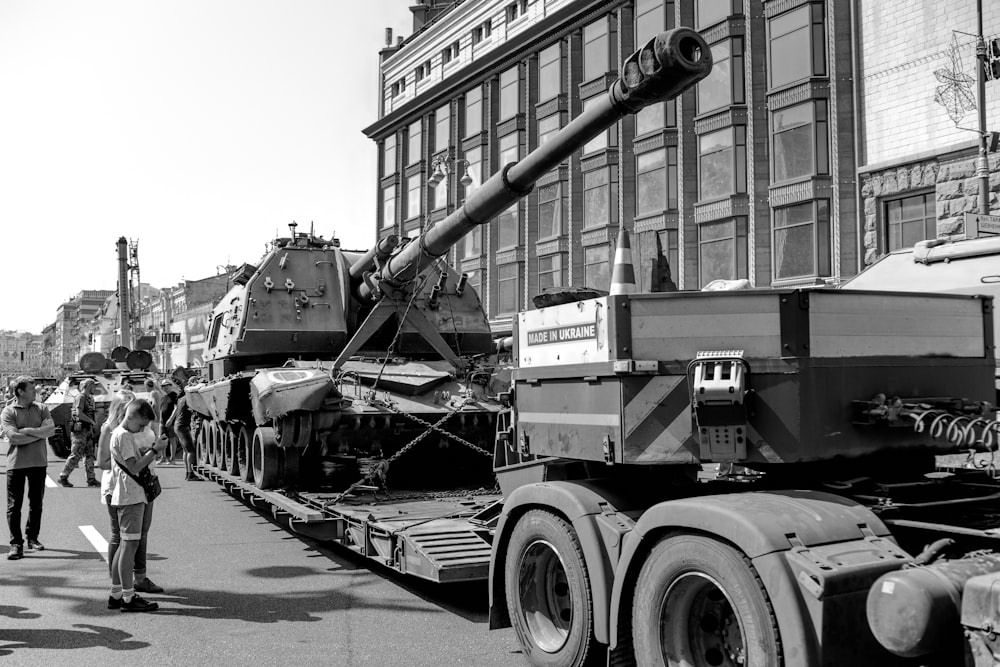 a black and white photo of a tank on a truck