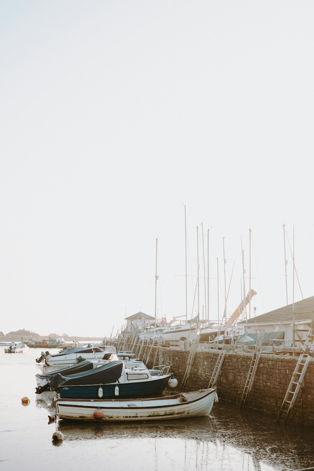 a row of boats sitting on top of a body of water