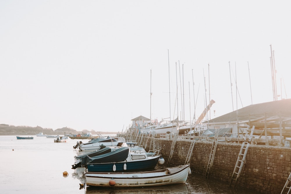 a row of boats sitting on top of a body of water