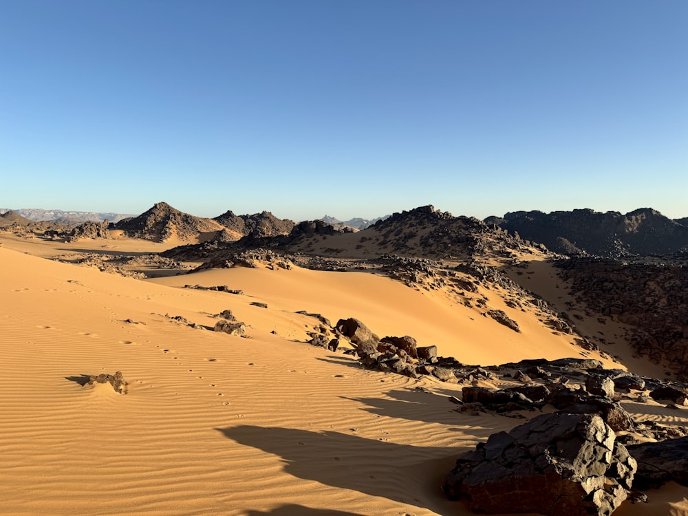 a view of a desert with rocks and sand