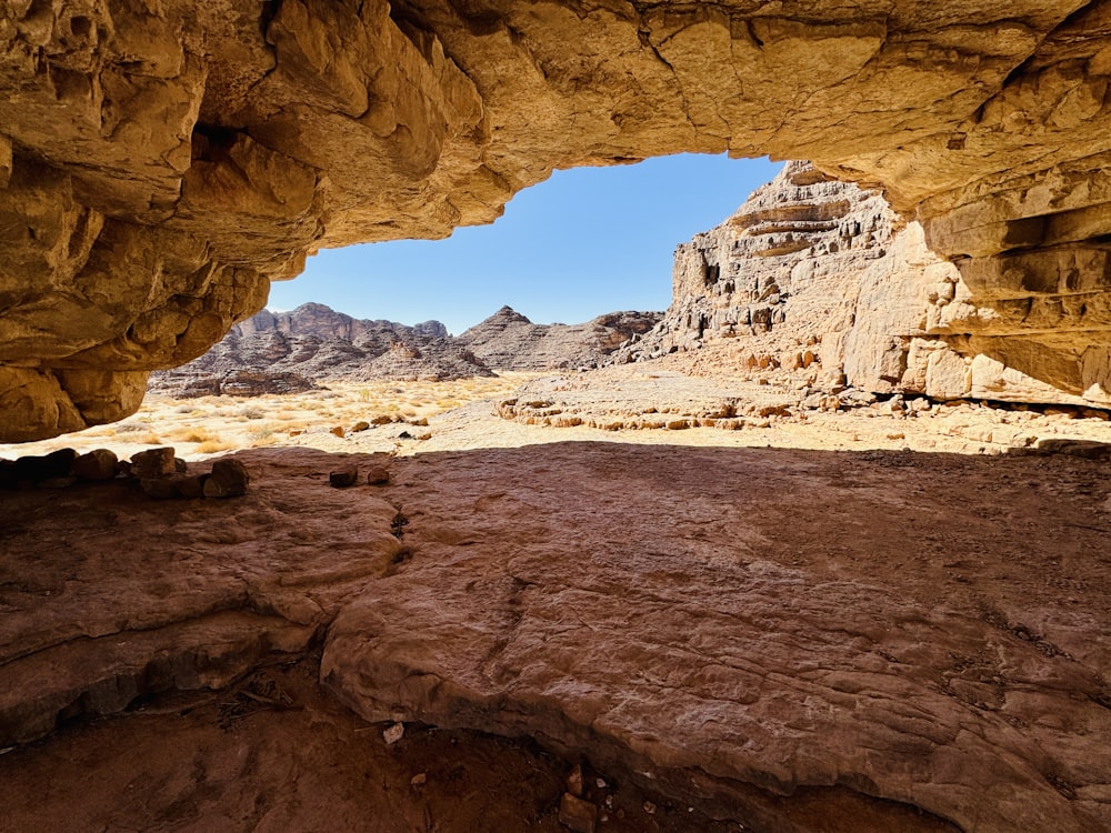 a view from inside a cave in the desert