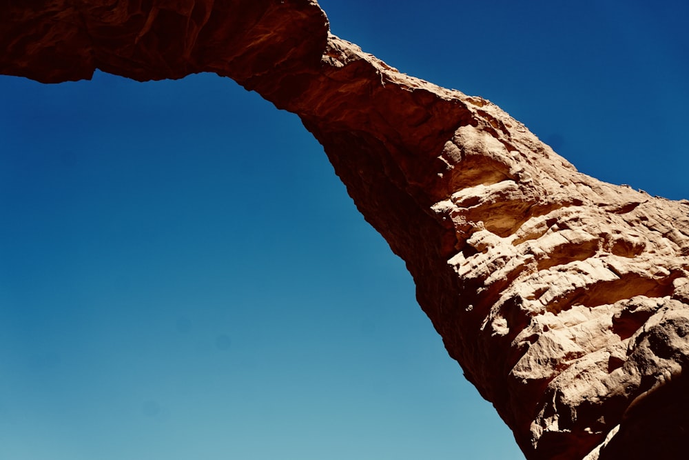 a very tall rock formation with a sky background