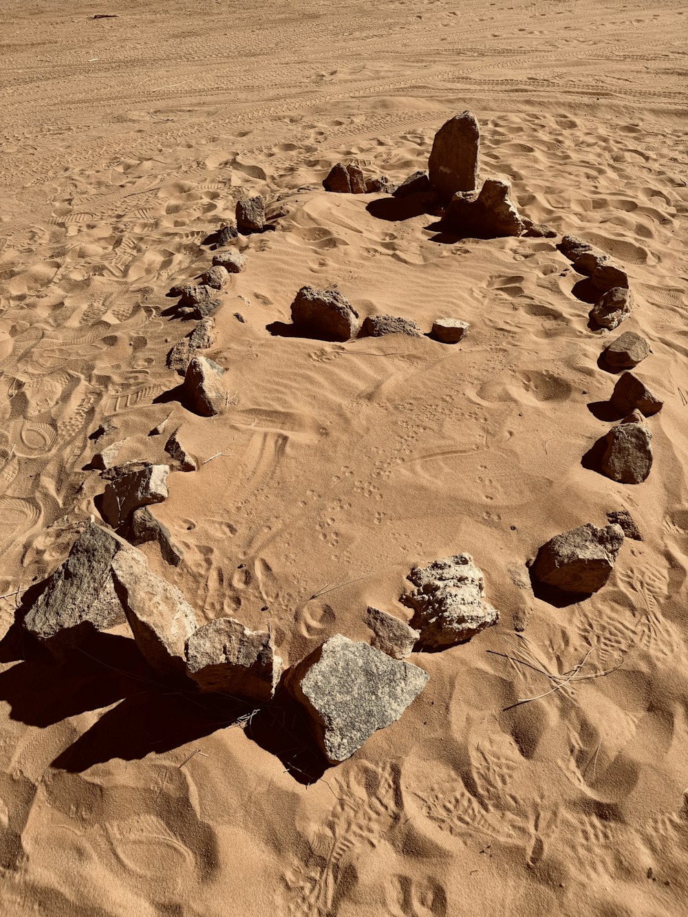 a circle made of rocks in the sand