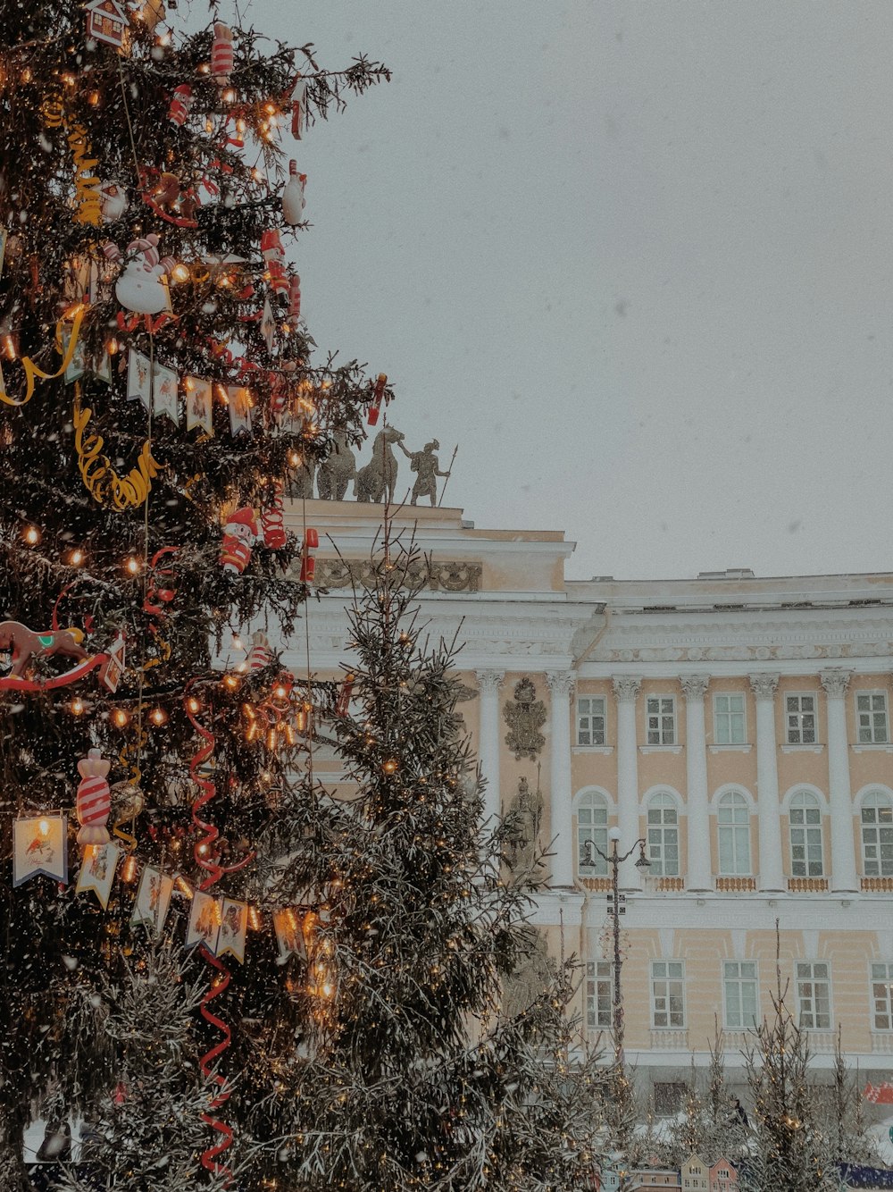 a christmas tree in front of a large building