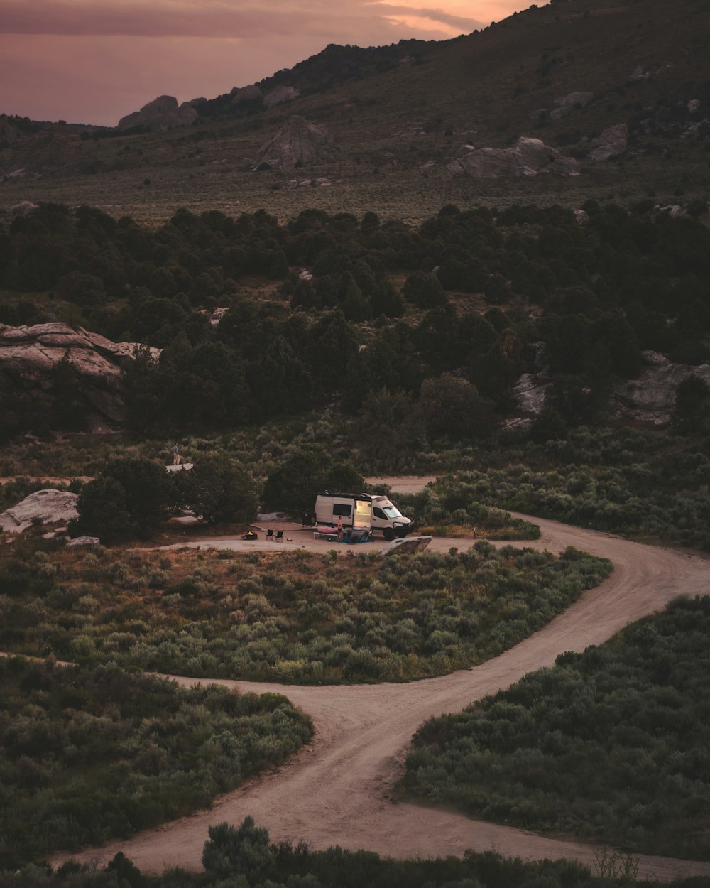 a truck is parked on a dirt road