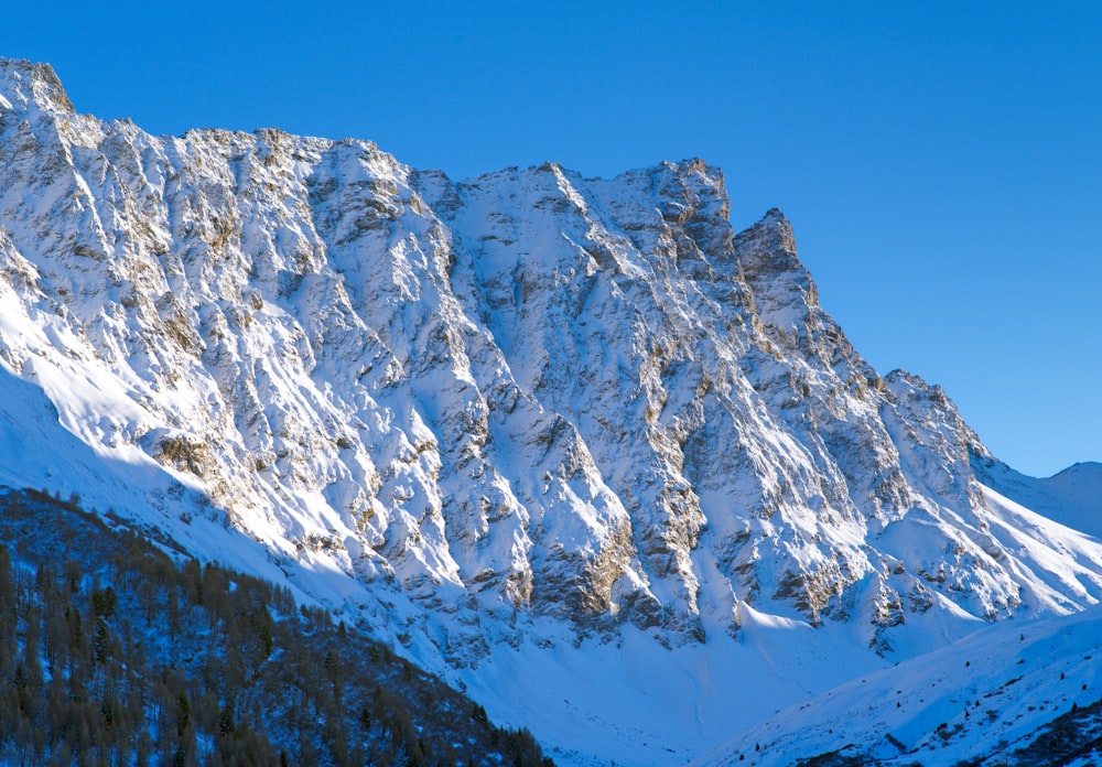 a snow covered mountain with a clear blue sky