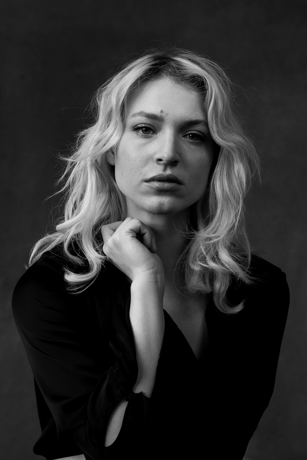 a woman posing for a black and white photo